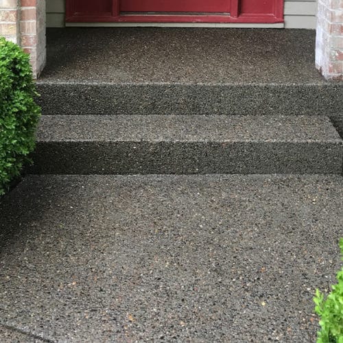 Exposed aggregate concrete finish on entryway and steps to home