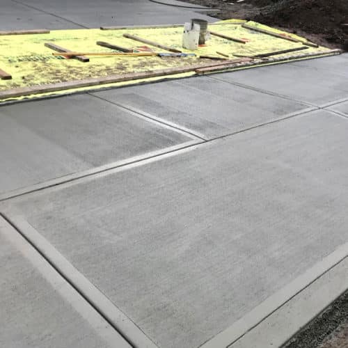 Concrete walkway out front of a driveway