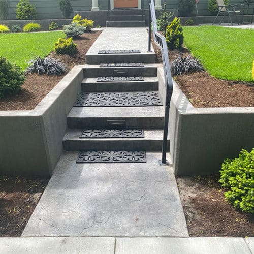 Long entrance with custom walkway and concrete steps