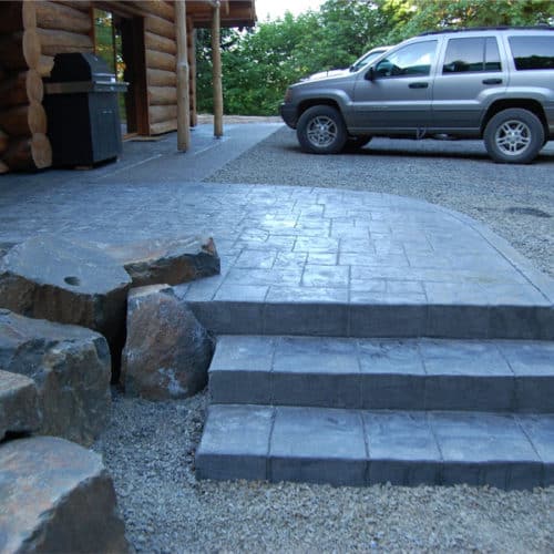 Concrete steps out front of a cabin style home