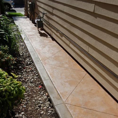 Concrete pathway around the side of a house