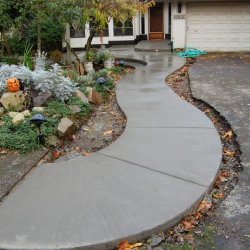 Curved concrete walkway leads to front porch