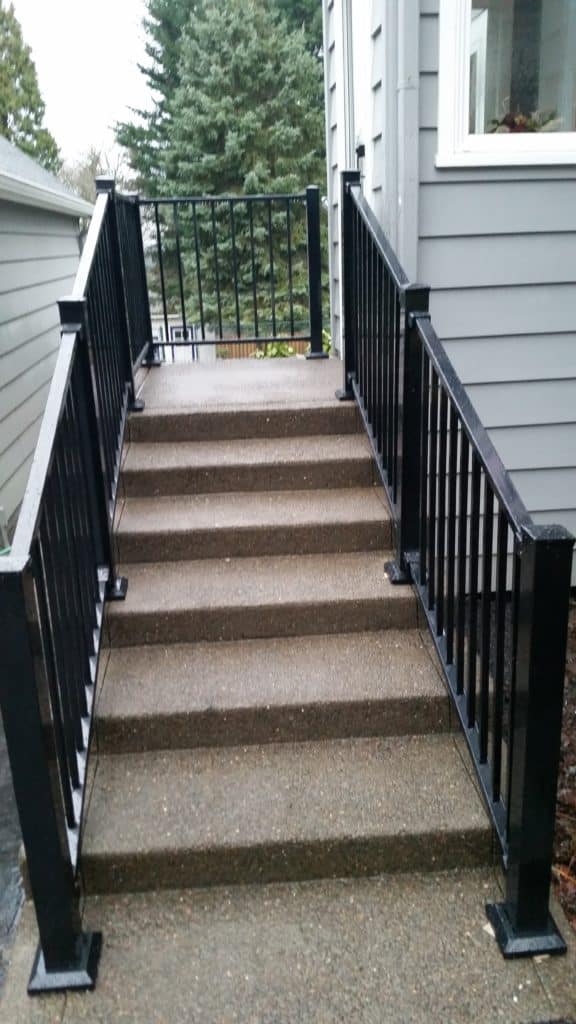 Steps up to a home are flanked by guard handrails