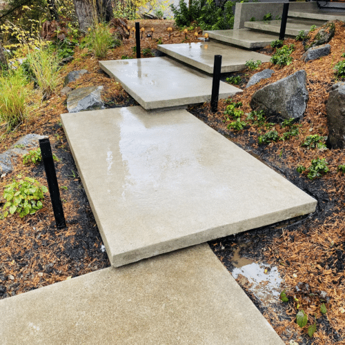 Concrete floating steps lead up to a custom home in Portland, Oregon by Allison Concrete Contractors