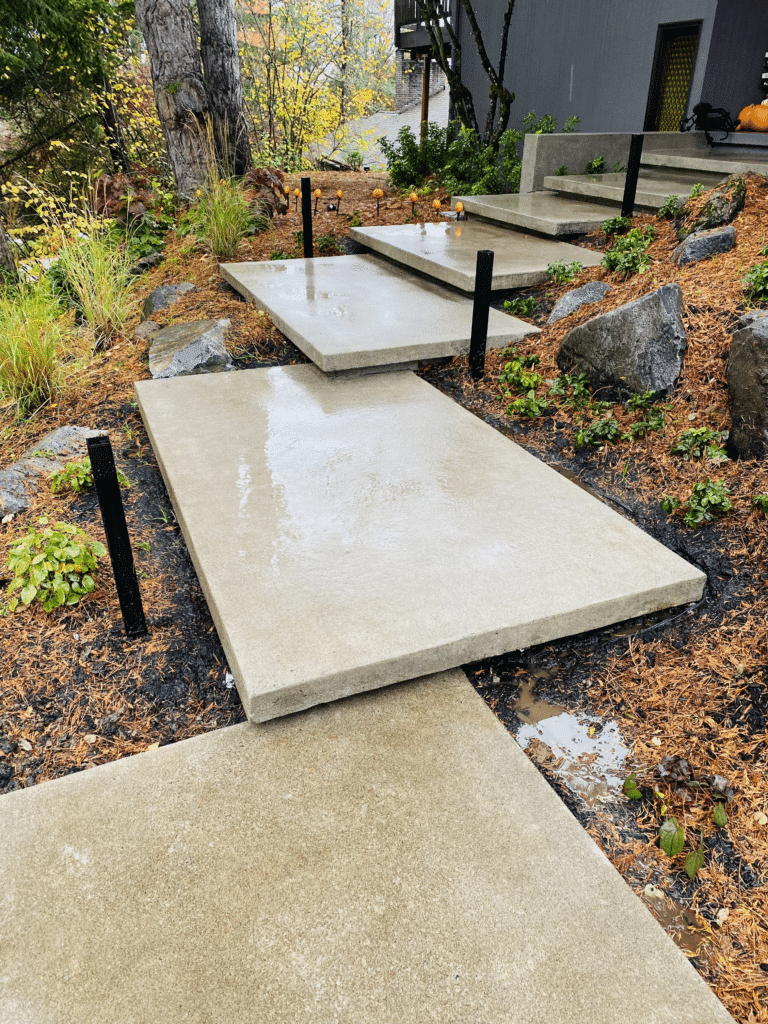 Concrete floating steps lead up to a custom home in Portland, Oregon by Allison Concrete Contractors