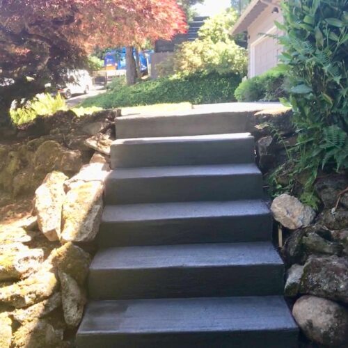 Concrete steps going up toward a front porch