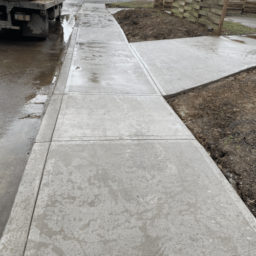 Concrete walkway leading up to a new home build