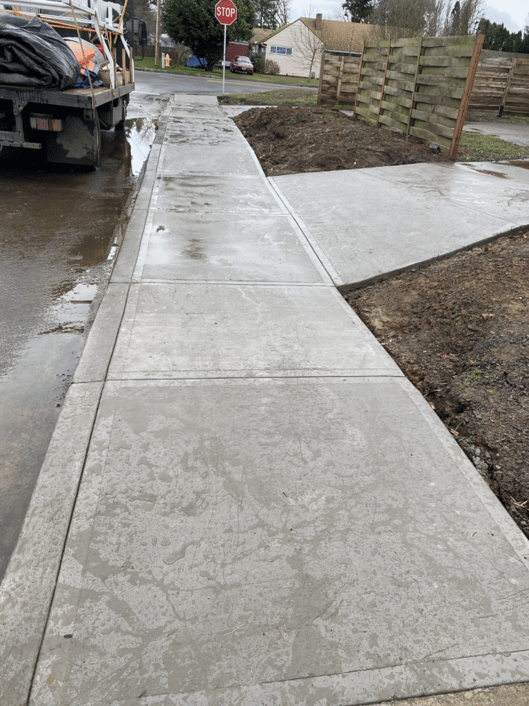 Concrete walkway leading up to a new home build