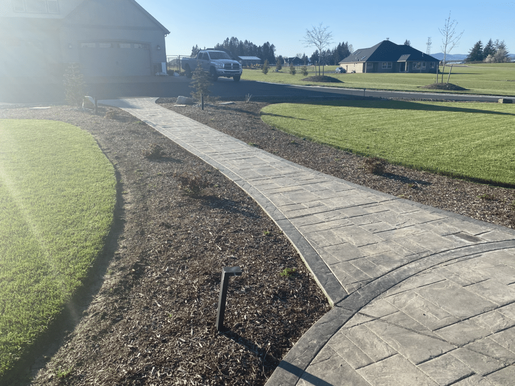 Stamped concrete walkway leads away from a circular space