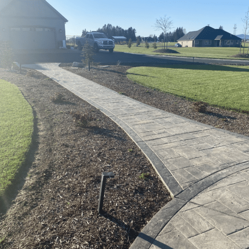 Stamped concrete walkway leads away from a circular space