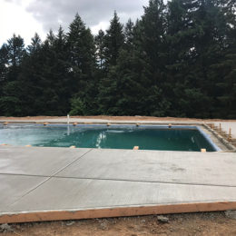 Broom finish concrete surrounds pool